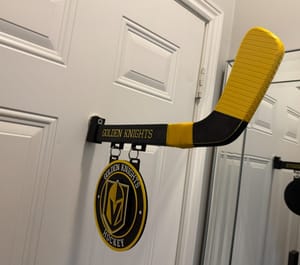 Hockey stick door hanger with team sign